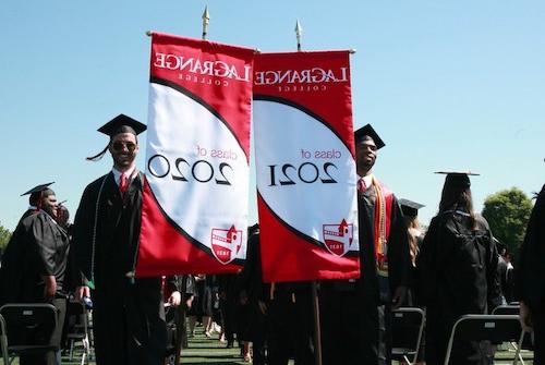 Students carrying class banners for 2020 and 2021 lead the processional